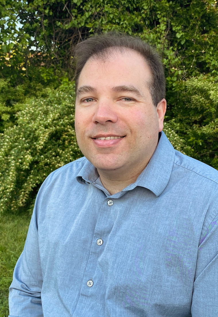 Headshot of James Tate Hill smiling outdoors
