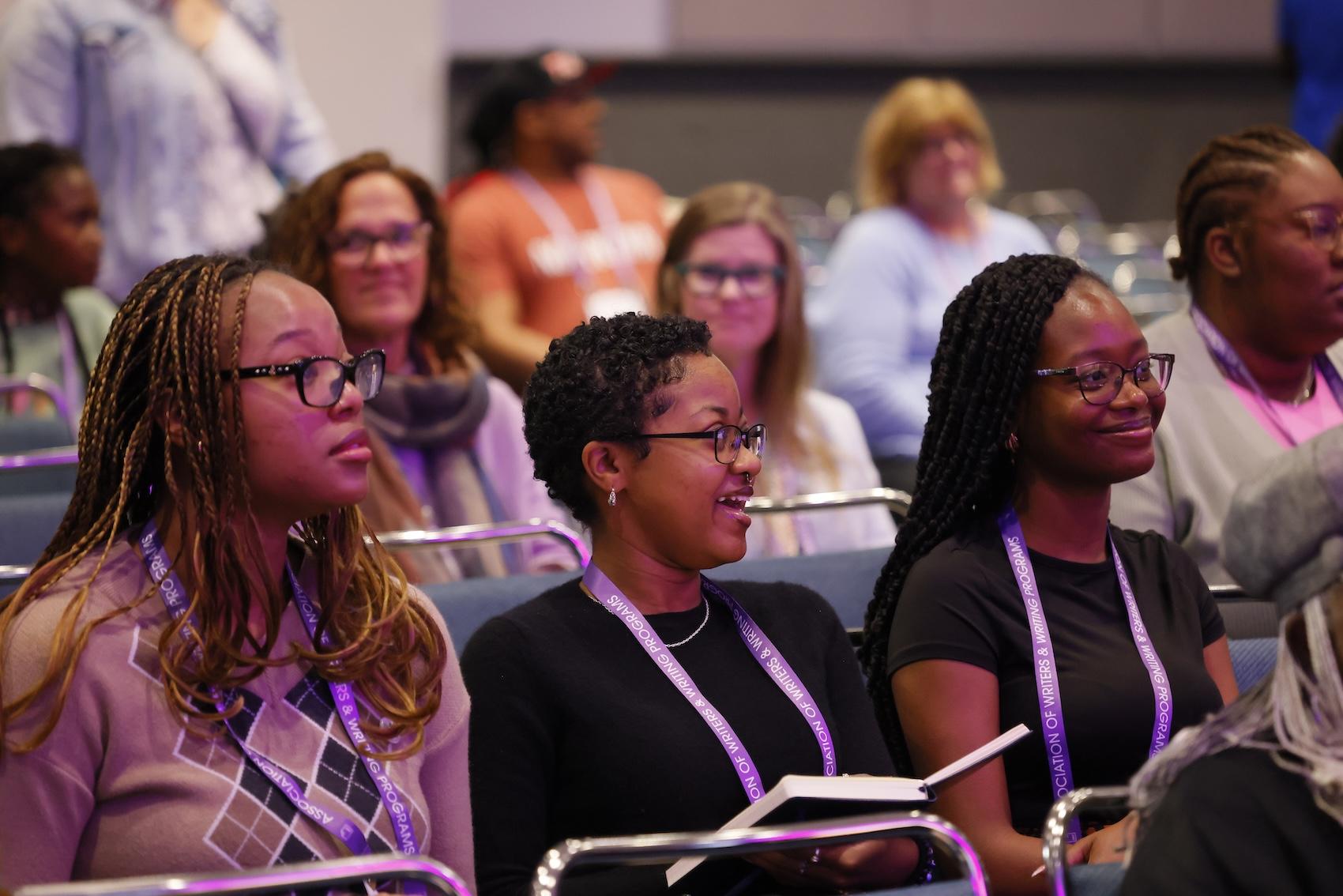 Three HBCU fellows smiling in the audience