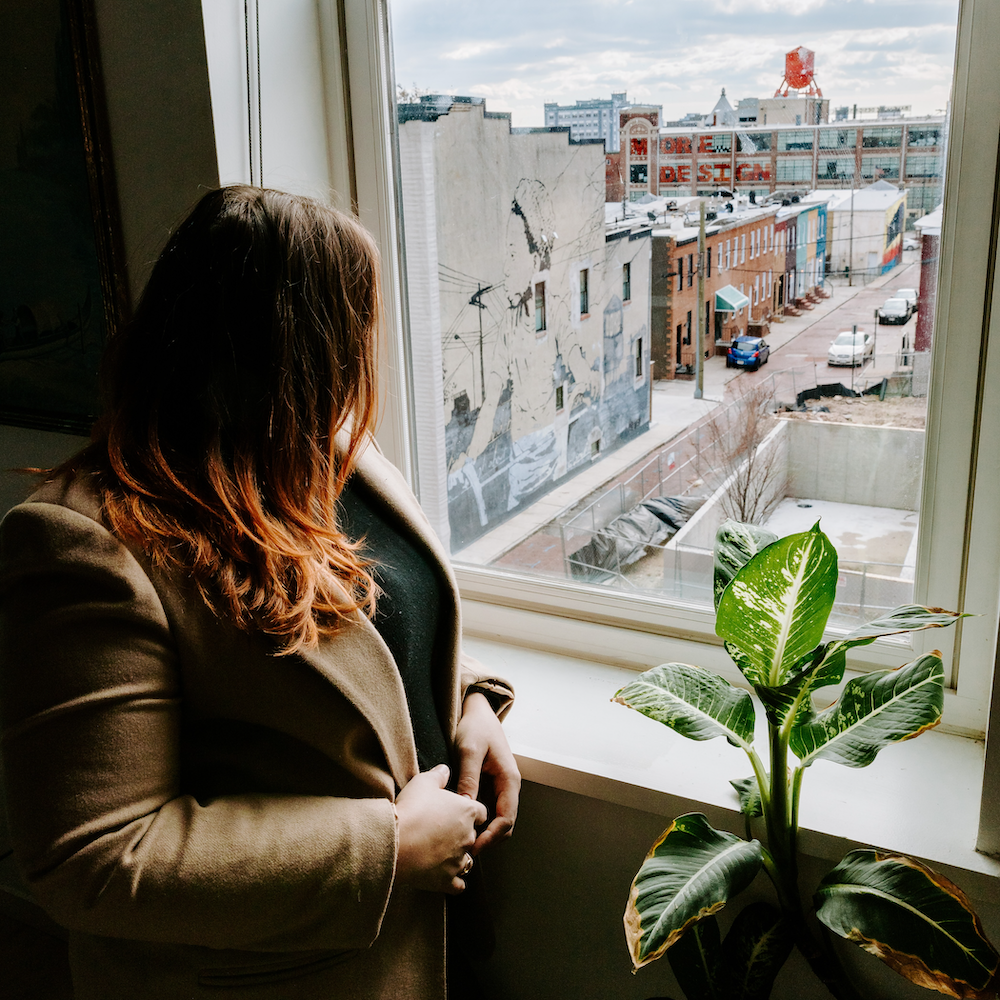 The author looking at a Baltimore street through a window